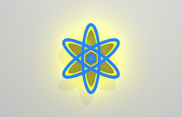 Leuchtendes Atom-Symbol in Blau und Gelb auf einem hellen Hintergrund als Ausdruck der Basis im Körper.
